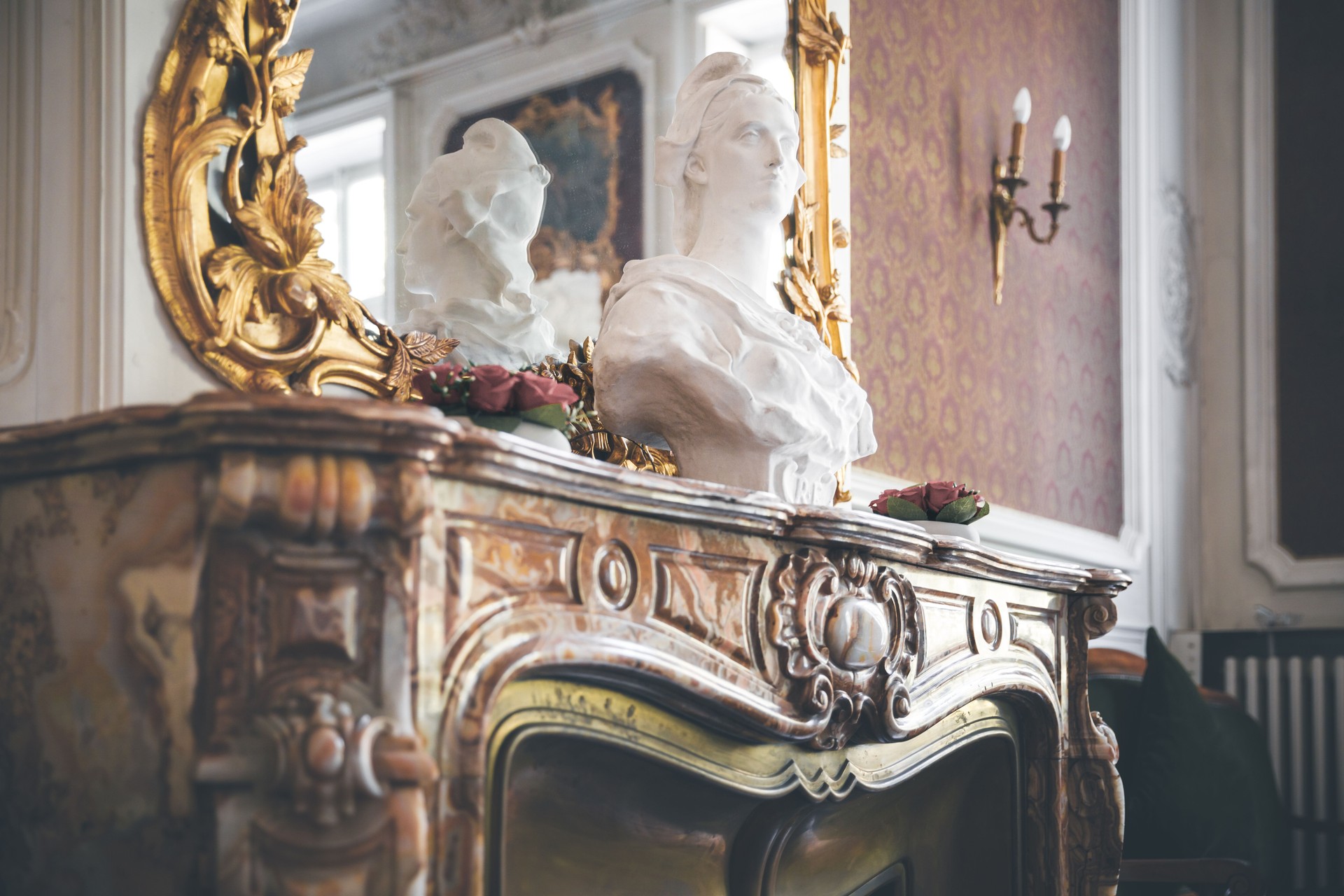 Marble bust of French symbol Marianne placed on beautiful ancient fireplace in Ambronay town hall