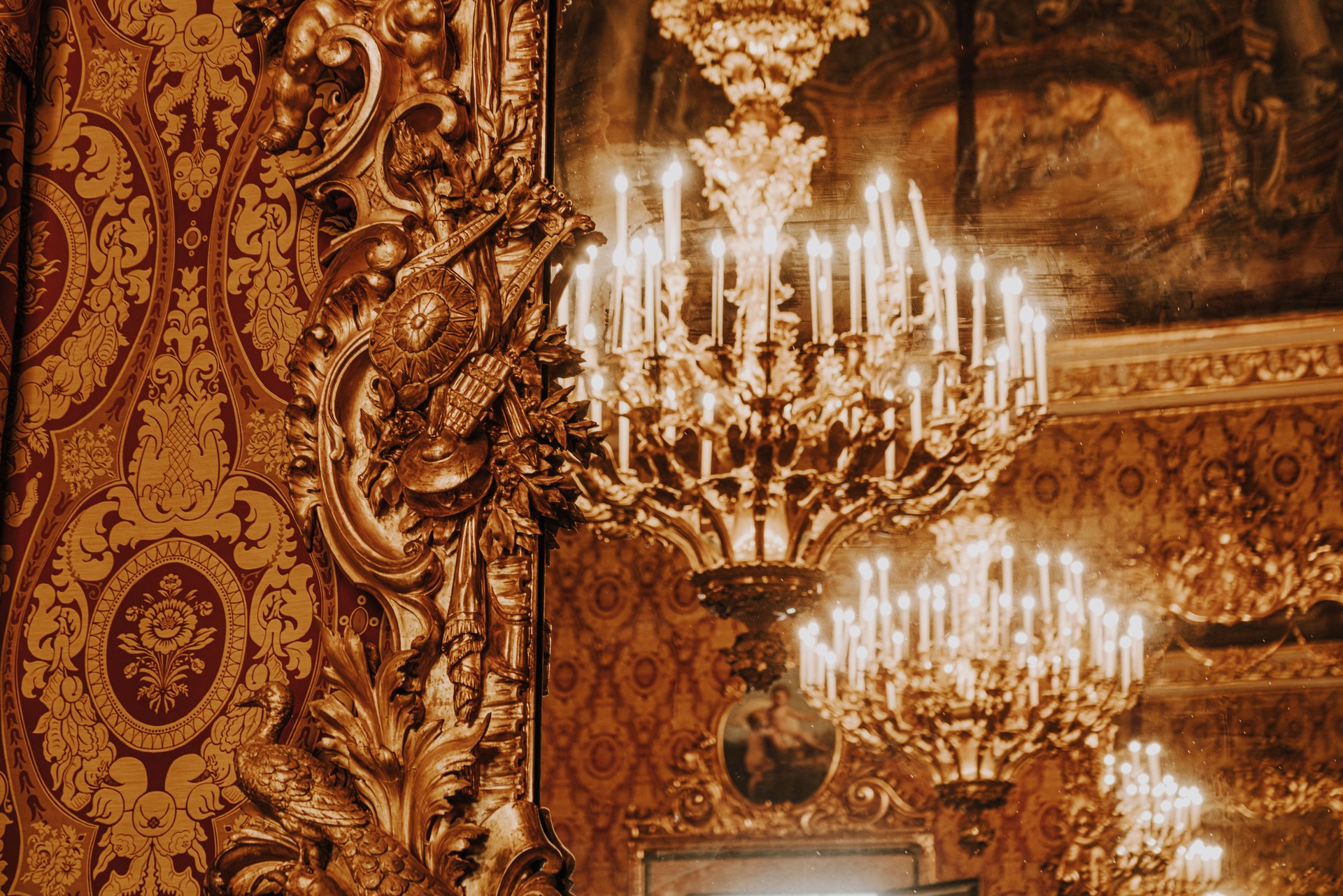 Luxurious Vintage Chandelier Reflected in Ornate Golden Mirror